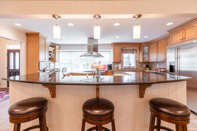 4000 E Stonegate Dr, Bloomington, IN 47401 - kitchen with island range hood, appliances with stainless steel finishes, glass insert cabinets, backsplash, and recessed lighting