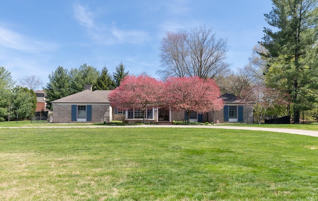 4000 E Stonegate Dr, Bloomington, IN 47401 - obstructed view of property featuring a front yard and a chimney