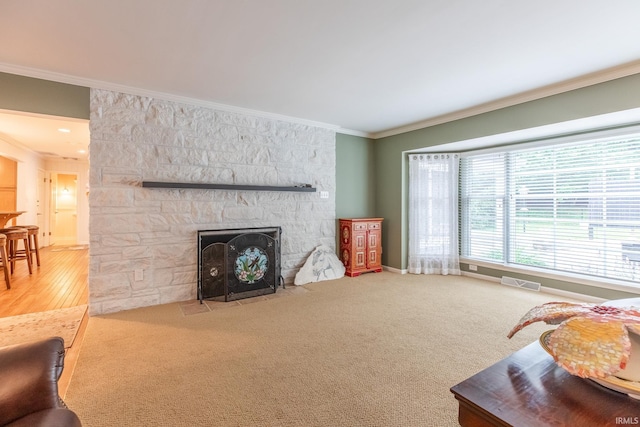 4000 E Stonegate Dr, Bloomington, IN 47401 - carpeted living room with crown molding, a fireplace, and baseboards