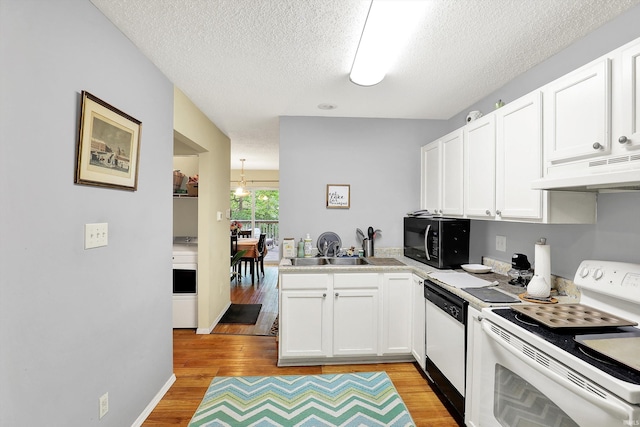 2210 S Laurelwood Cir, Bloomington, IN 47401 - kitchen with white appliances, under cabinet range hood, light wood-style flooring, a textured ceiling, and white cabinets