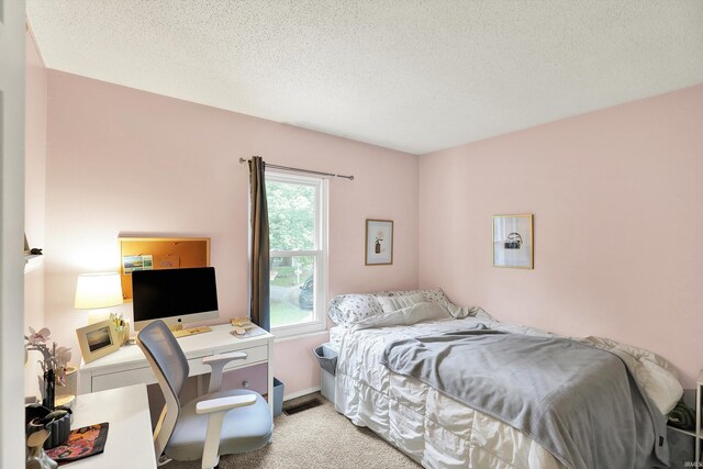 2210 S Laurelwood Cir, Bloomington, IN 47401 - bedroom featuring light carpet, a textured ceiling, an office area, and baseboards