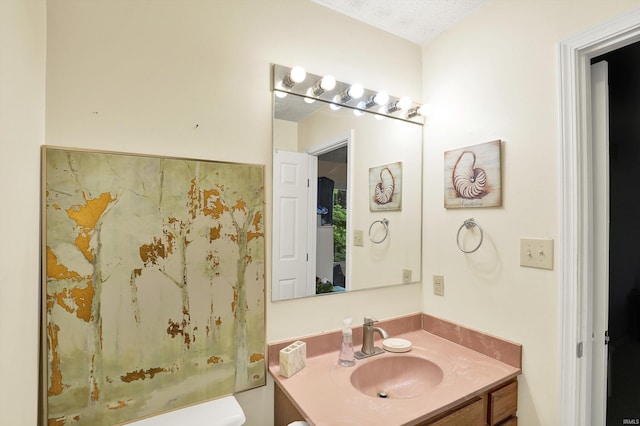 2210 S Laurelwood Cir, Bloomington, IN 47401 - bathroom with vanity, toilet, and a textured ceiling