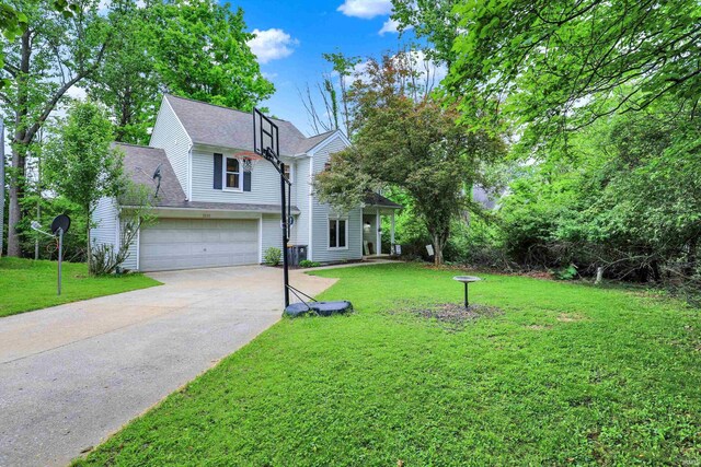 2210 S Laurelwood Cir, Bloomington, IN 47401 - view of front facade featuring concrete driveway, a front lawn, a garage, and roof with shingles