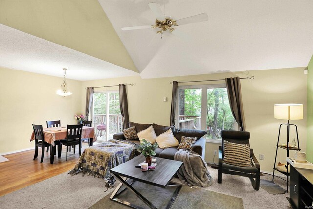 2210 S Laurelwood Cir, Bloomington, IN 47401 - living area featuring ceiling fan, lofted ceiling, baseboards, a chandelier, and light wood-style flooring