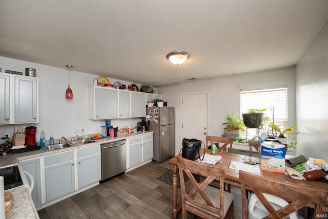 116 Wise Dr, Lafayette, IN 47909 - kitchen with stainless steel appliances, a sink, light countertops, dark wood-style floors, and white cabinets