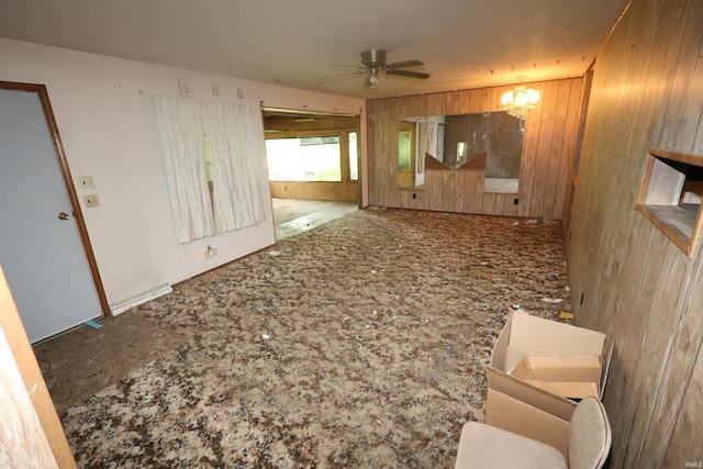 56825 Elmer Ave, South Bend, IN 46619 - spare room with wood walls, ceiling fan, and a chandelier