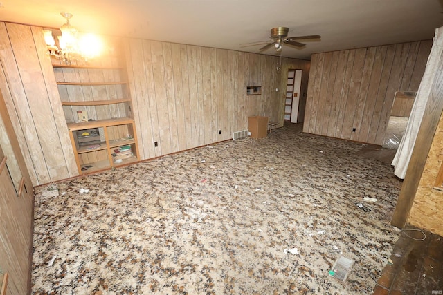 56825 Elmer Ave, South Bend, IN 46619 - empty room with a ceiling fan, wooden walls, and a chandelier