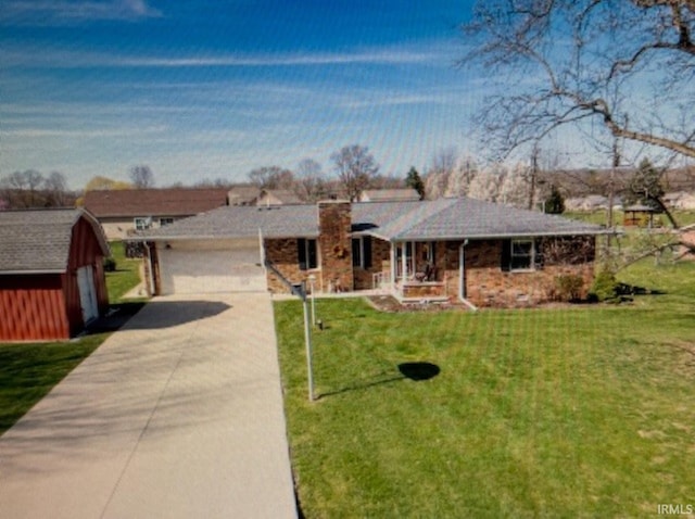 1880 N Michael Dr, Marion, IN 46952 - single story home with a front lawn, a porch, concrete driveway, a chimney, and an outbuilding