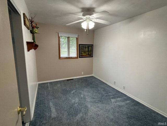 1880 N Michael Dr, Marion, IN 46952 - spare room featuring a ceiling fan, dark colored carpet, and baseboards