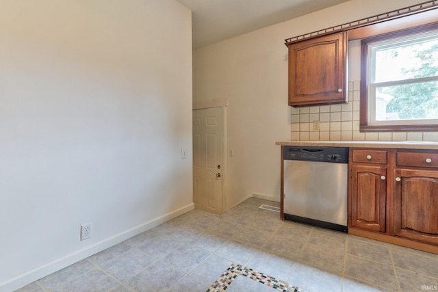 2305 E Virginia St, Evansville, IN 47711 - kitchen featuring stainless steel dishwasher, backsplash, light countertops, and brown cabinetry