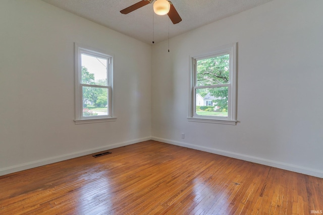 2305 E Virginia St, Evansville, IN 47711 - empty room with light wood-style flooring, plenty of natural light, a ceiling fan, and baseboards