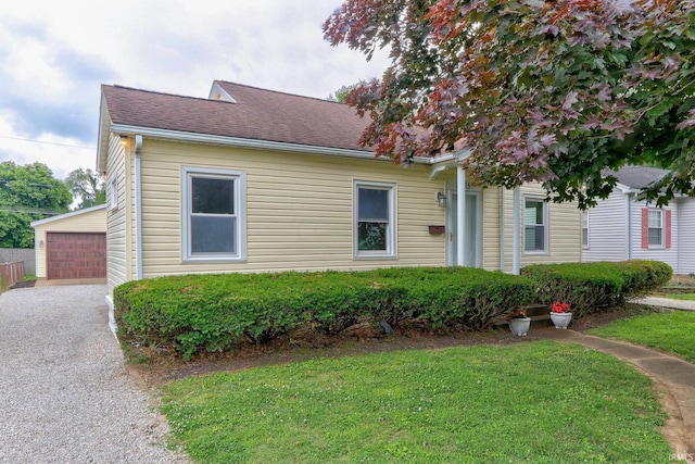 2305 E Virginia St, Evansville, IN 47711 - view of front of house featuring a front yard, an outdoor structure, a detached garage, and roof with shingles