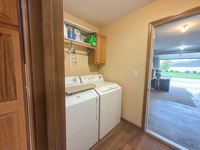 204 Coronet St, Angola, IN 46703 - laundry room with cabinet space, washer and dryer, dark wood-style flooring, and baseboards