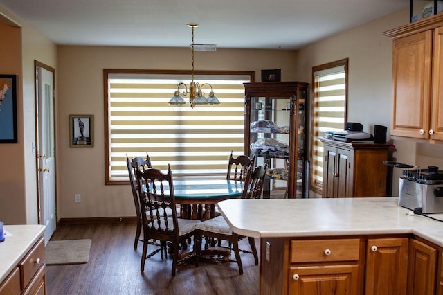 204 Coronet St, Angola, IN 46703 - dining space with dark wood finished floors, a chandelier, and baseboards