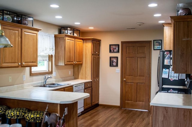 204 Coronet St, Angola, IN 46703 - kitchen featuring a sink, white dishwasher, dark wood-style flooring, light countertops, and recessed lighting