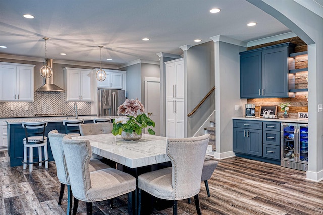 4308 Martha Ct, Newburgh, IN 47630 - dining area with wine cooler, recessed lighting, ornamental molding, dark wood finished floors, and baseboards