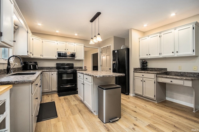 50576 W Park Ln, Granger, IN 46530 - kitchen with black appliances, a sink, light wood-style floors, pendant lighting, and recessed lighting