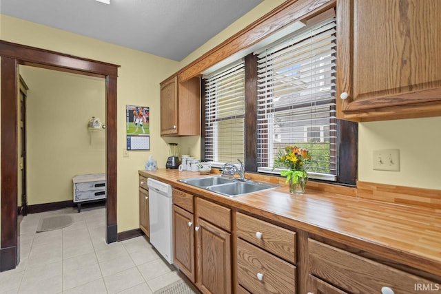 1010 W Sycamore St, Kokomo, IN 46901 - kitchen featuring a sink, butcher block countertops, white dishwasher, light tile patterned floors, and brown cabinetry