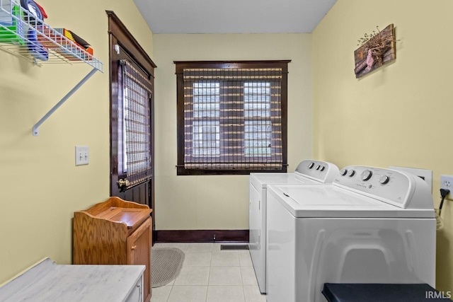 1010 W Sycamore St, Kokomo, IN 46901 - washroom featuring washing machine and dryer, light tile patterned floors, plenty of natural light, and baseboards