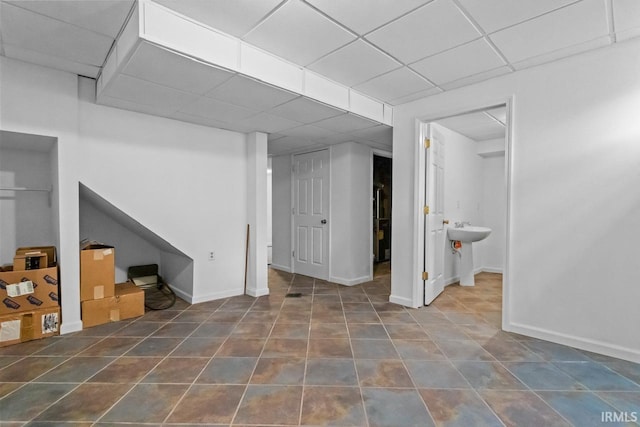 1010 W Sycamore St, Kokomo, IN 46901 - below grade area with a drop ceiling, tile patterned flooring, baseboards, and a sink