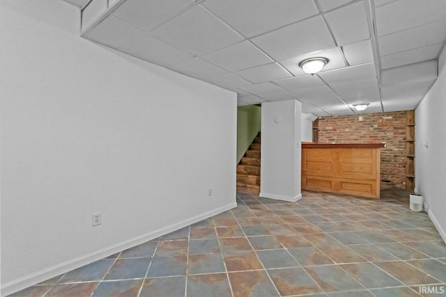 1010 W Sycamore St, Kokomo, IN 46901 - finished basement with stairs, baseboards, a paneled ceiling, and tile patterned flooring