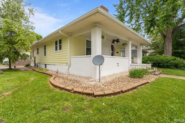 1010 W Sycamore St, Kokomo, IN 46901 - view of side of property featuring a chimney and a lawn