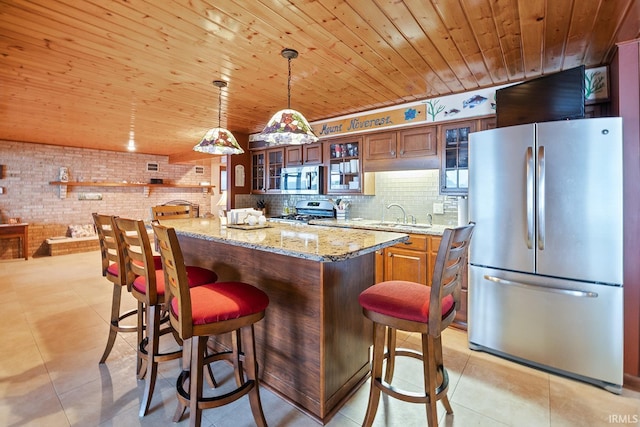 8818 N 1132 W, Monticello, IN 47960 - kitchen featuring stainless steel appliances, wooden ceiling, a sink, brown cabinets, and decorative light fixtures