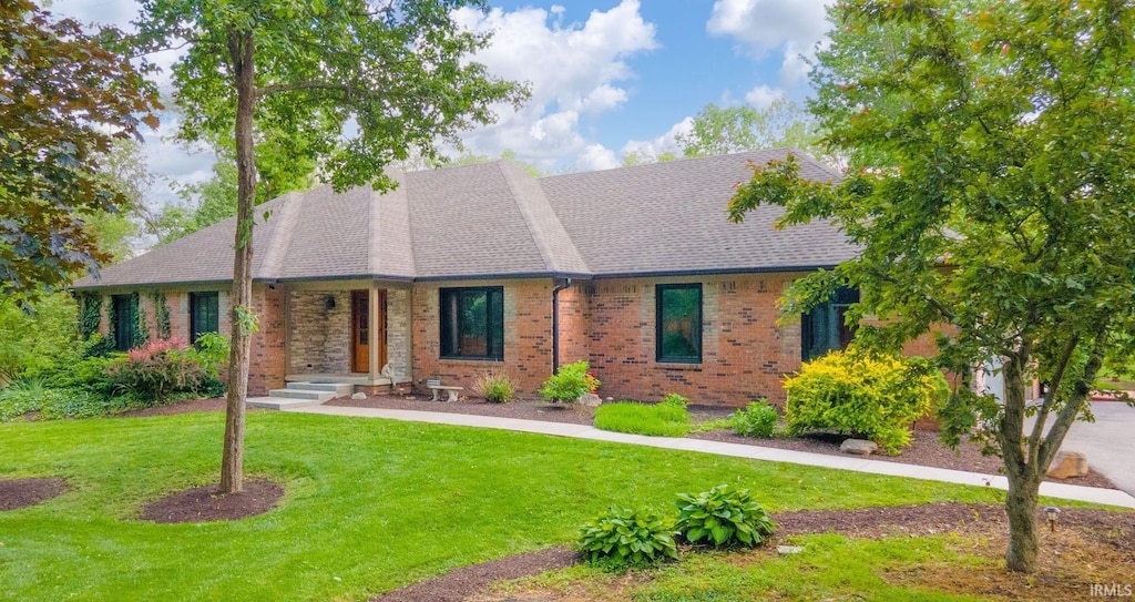1633 W 200 N, Greenfield, IN 46140 - view of front of house with brick siding, a front yard, and a shingled roof