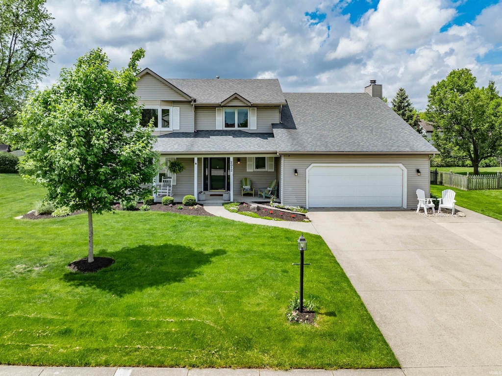 2312 Hunters Cv, Fort Wayne, IN 46804 - view of front of property with a garage, a porch, driveway, a chimney, and roof with shingles