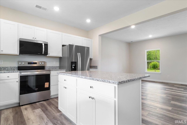 5582 Hillside Trl, Newburgh, IN 47630 - kitchen with appliances with stainless steel finishes, light wood-style flooring, recessed lighting, a kitchen island, and white cabinetry