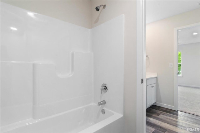 5582 Hillside Trl, Newburgh, IN 47630 - bathroom featuring vanity, wood finished floors, washtub / shower combination, and baseboards
