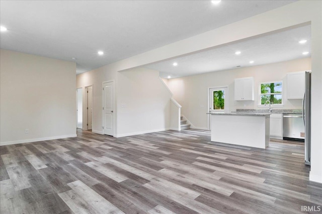 5582 Hillside Trl, Newburgh, IN 47630 - unfurnished living room with recessed lighting, stairway, light wood finished floors, and baseboards