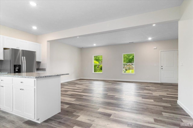 5582 Hillside Trl, Newburgh, IN 47630 - kitchen featuring stainless steel fridge with ice dispenser, white cabinets, wood finished floors, baseboards, and light stone countertops