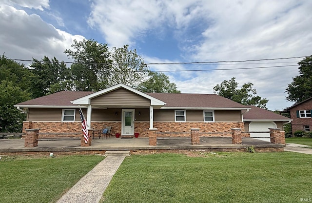 2124 Lakeview Dr, Washington, IN 47501 - ranch-style house with a front lawn, covered porch, a garage, and brick siding