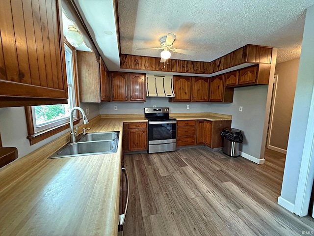 2124 Lakeview Dr, Washington, IN 47501 - kitchen featuring stainless steel range with electric cooktop, a sink, brown cabinets, light countertops, and a ceiling fan