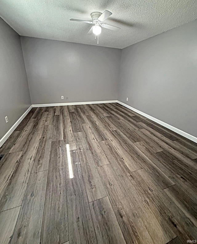 2124 Lakeview Dr, Washington, IN 47501 - empty room with dark wood finished floors, a ceiling fan, a textured ceiling, and baseboards