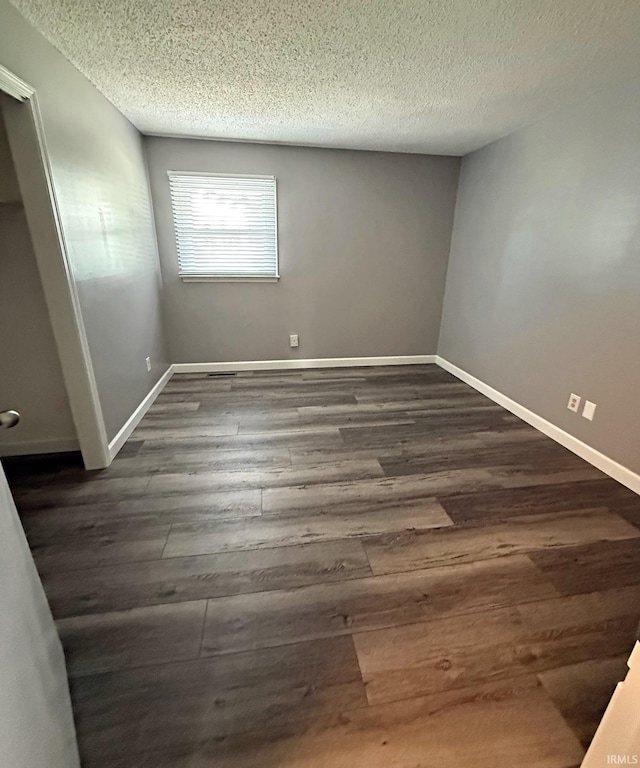 2124 Lakeview Dr, Washington, IN 47501 - unfurnished bedroom with dark wood-style floors, a textured ceiling, and baseboards