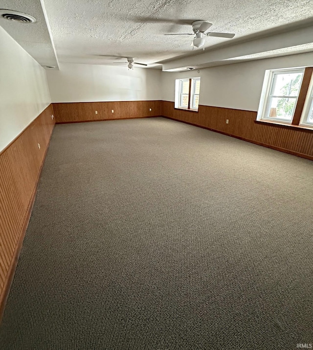 2124 Lakeview Dr, Washington, IN 47501 - carpeted spare room with wainscoting, wood walls, ceiling fan, and a textured ceiling