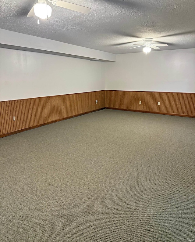 2124 Lakeview Dr, Washington, IN 47501 - unfurnished room featuring a wainscoted wall, ceiling fan, a textured ceiling, and wood walls
