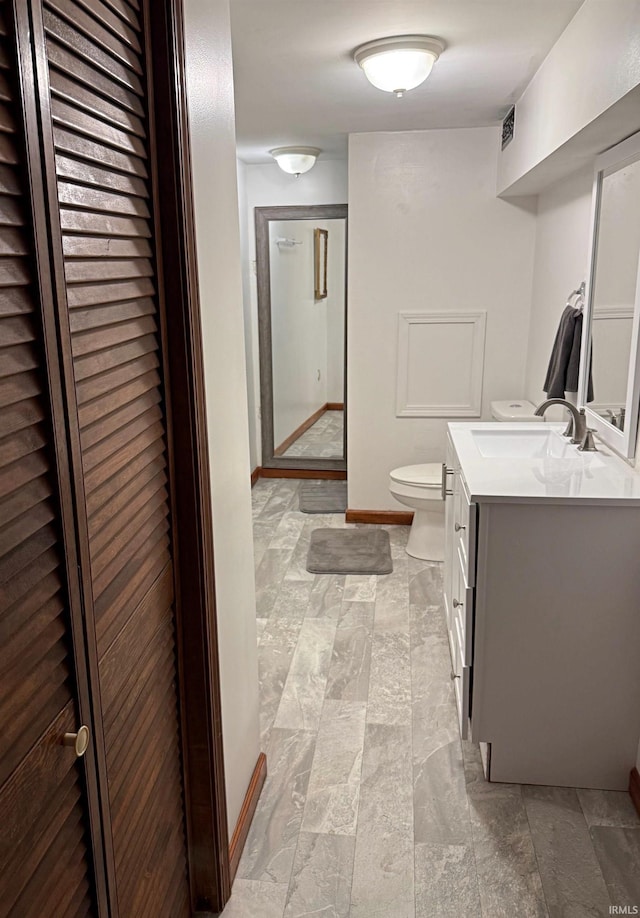 2124 Lakeview Dr, Washington, IN 47501 - bathroom featuring vanity, toilet, a stall shower, and baseboards