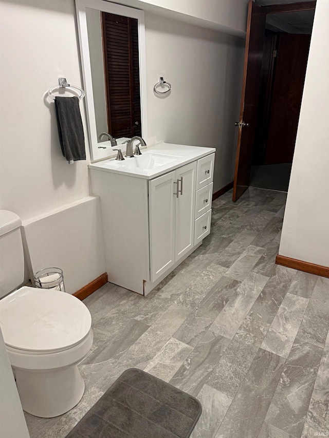 2124 Lakeview Dr, Washington, IN 47501 - bathroom with toilet, vanity, and baseboards