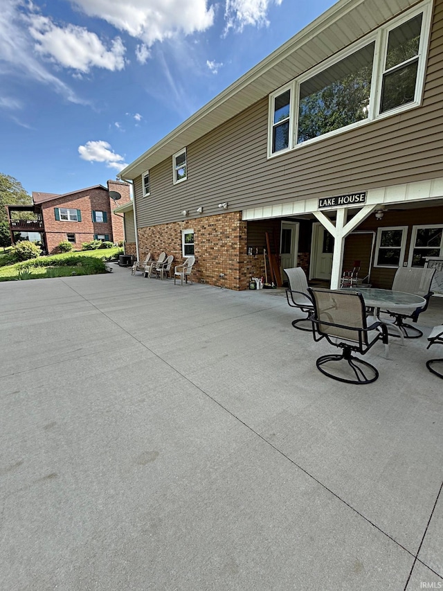 2124 Lakeview Dr, Washington, IN 47501 - rear view of house with a patio and brick siding