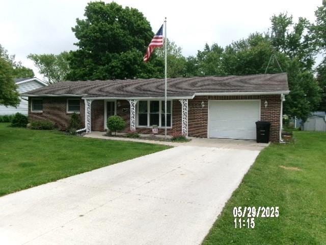 705 W W Spg, Fremont, IN 46737 - ranch-style house with an attached garage, driveway, a front yard, and brick siding