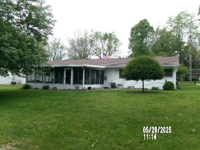 705 W W Spg, Fremont, IN 46737 - rear view of house with a sunroom, a yard, cooling unit, and a chimney