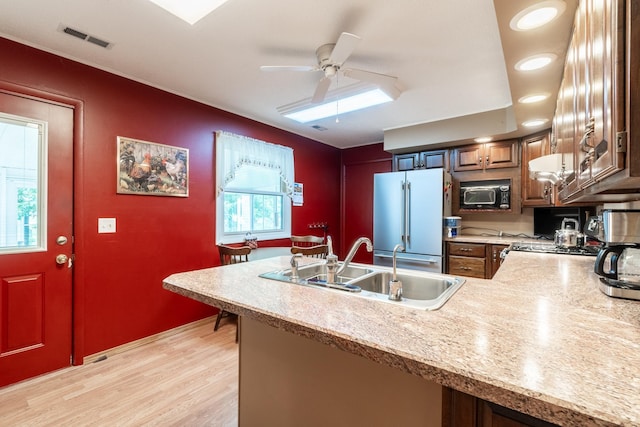 705 W W Spg, Fremont, IN 46737 - kitchen featuring fridge, a sink, a peninsula, light countertops, and a ceiling fan