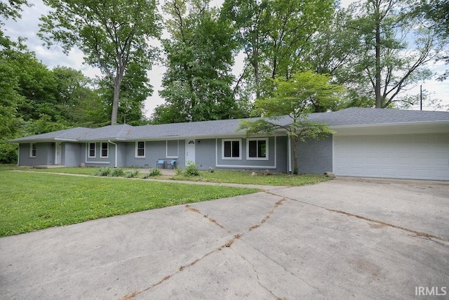 1034 Harter Blvd, Anderson, IN 46011 - single story home with driveway, a garage, a front lawn, and brick siding