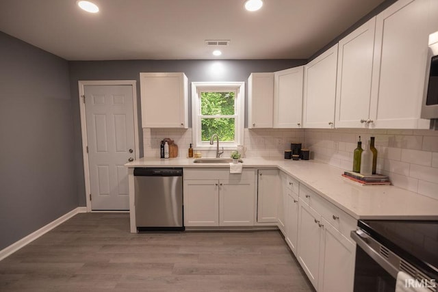 1034 Harter Blvd, Anderson, IN 46011 - kitchen featuring stainless steel dishwasher, a sink, decorative backsplash, white cabinets, and recessed lighting