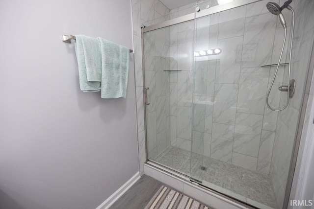 1034 Harter Blvd, Anderson, IN 46011 - bathroom with a stall shower, baseboards, and wood finished floors