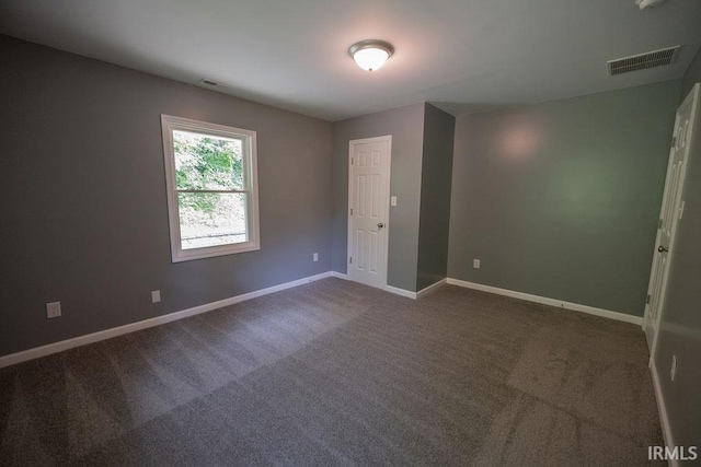 1034 Harter Blvd, Anderson, IN 46011 - spare room with baseboards and dark carpet