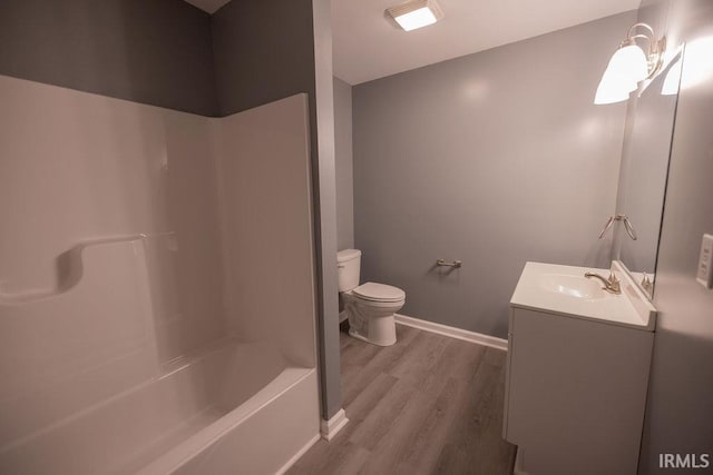 1034 Harter Blvd, Anderson, IN 46011 - full bathroom featuring vanity, wood finished floors, toilet, baseboards, and washtub / shower combination